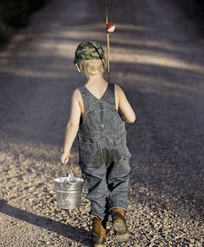 little boy walking down a road